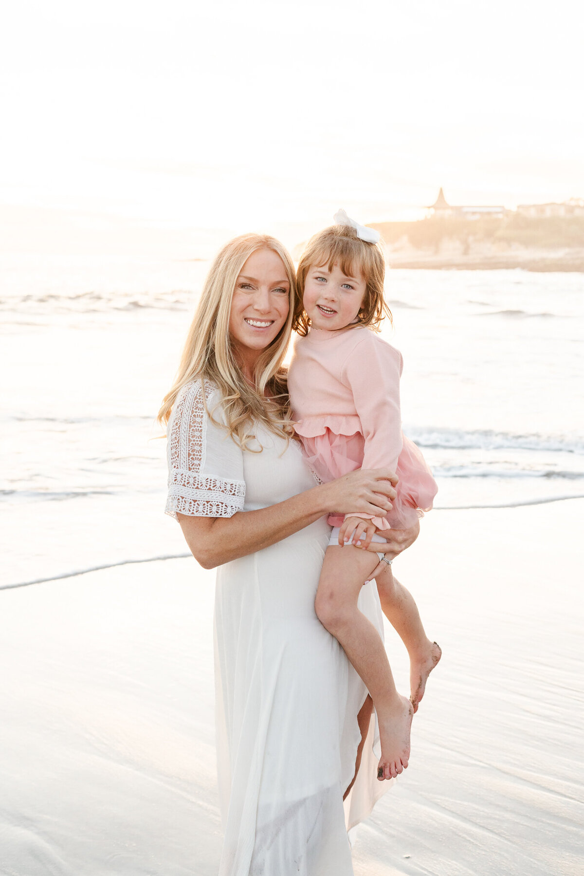 mother and daughter at the beach during a family photo session