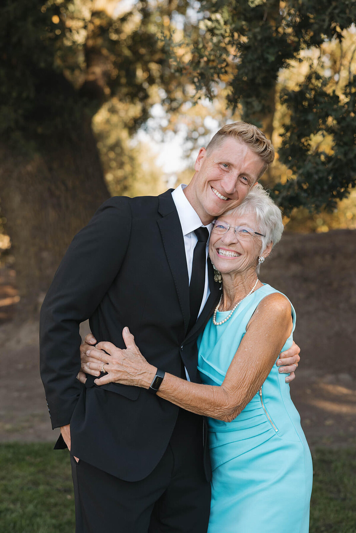 Groom laughing with his grandma during family photos