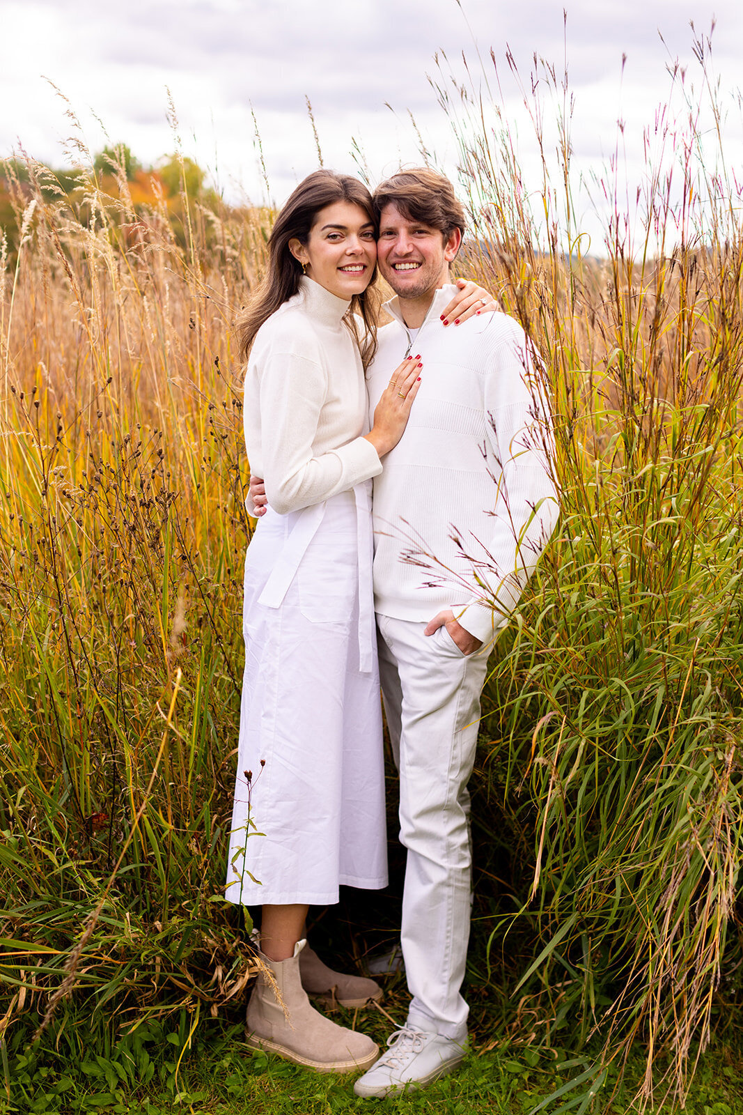 couple dressed in white in a tall dry grass field