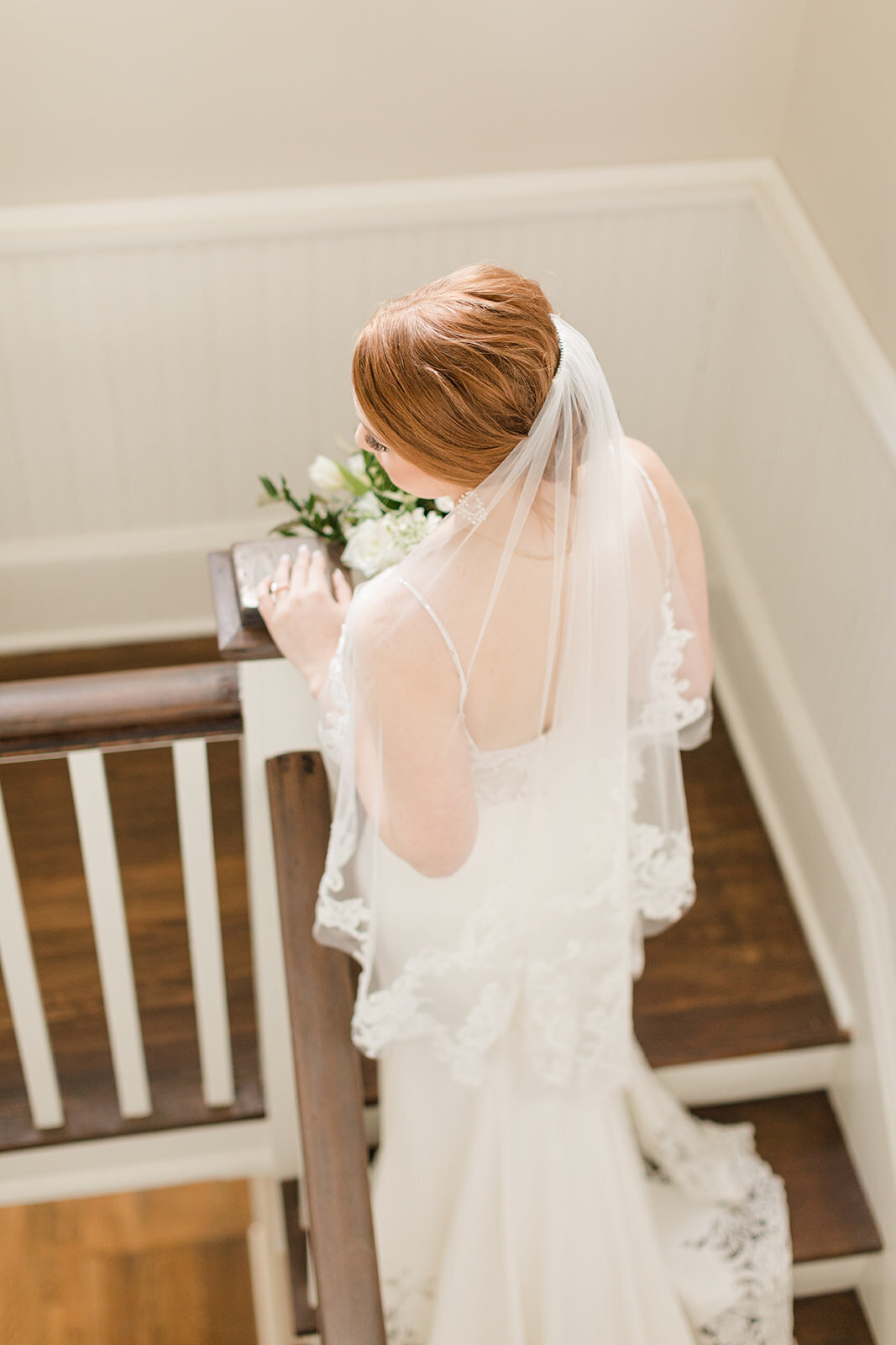 Bride ascending stairs at Venue de LaChute; Shreveport, Louisiana