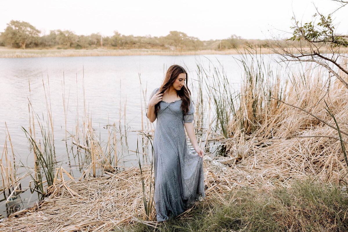 Lubbock senior walking next to the lake in Lubbock Texas.