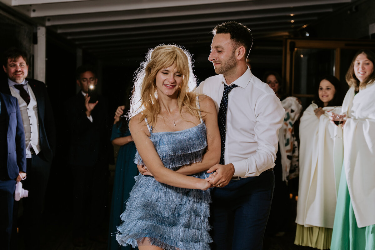 Bride and groom dancing during wedding reception in Italy