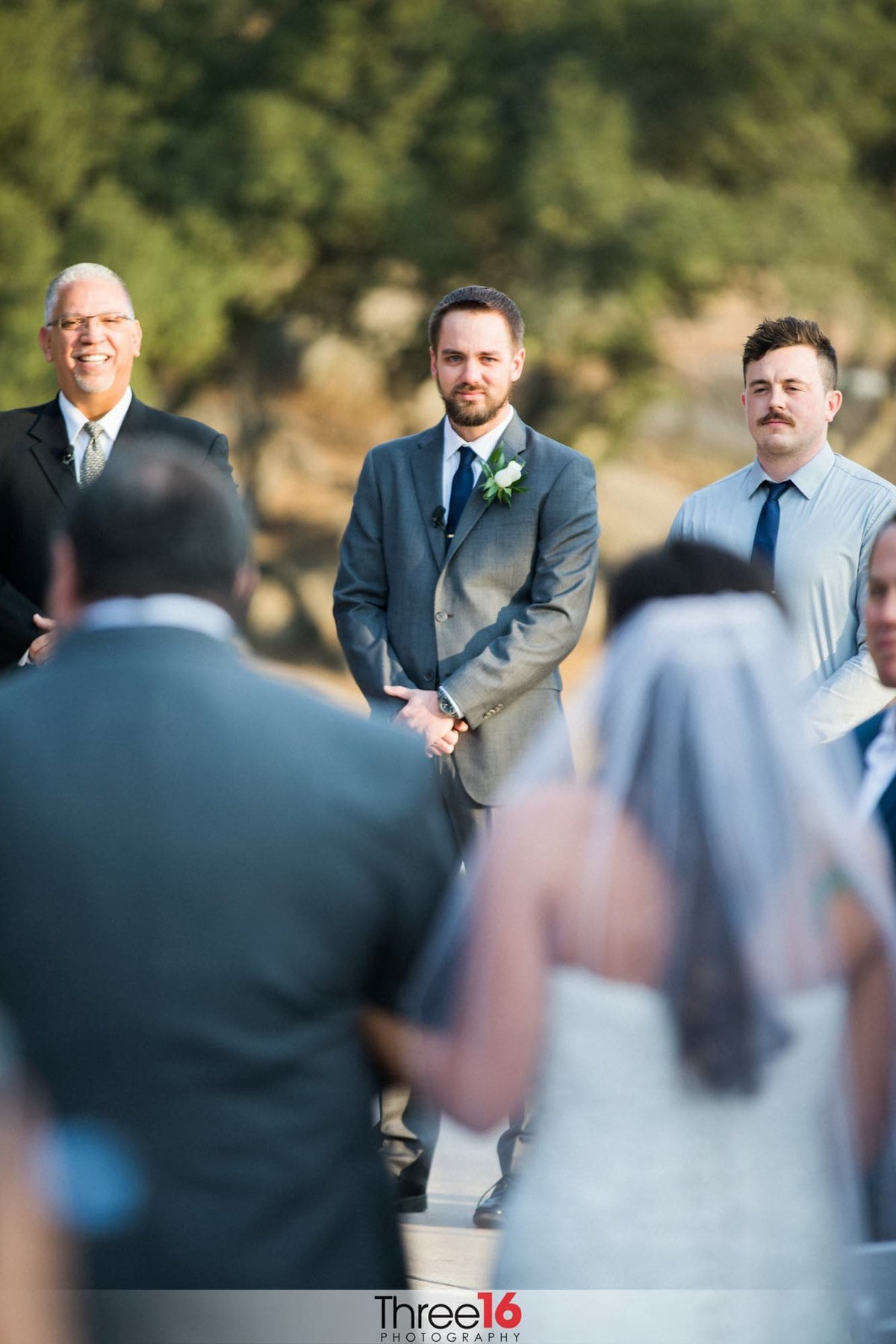 Groom at the altar watching Bride approaching