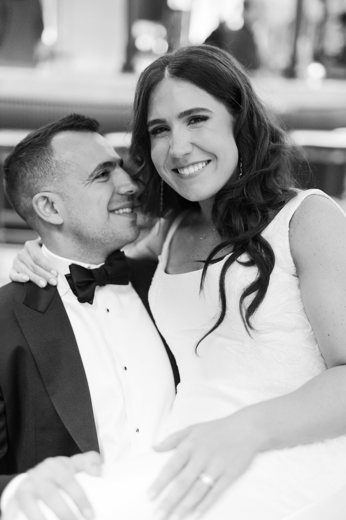 Bride and groom cuddling at the elopement at the Book Tower in Detroit. 