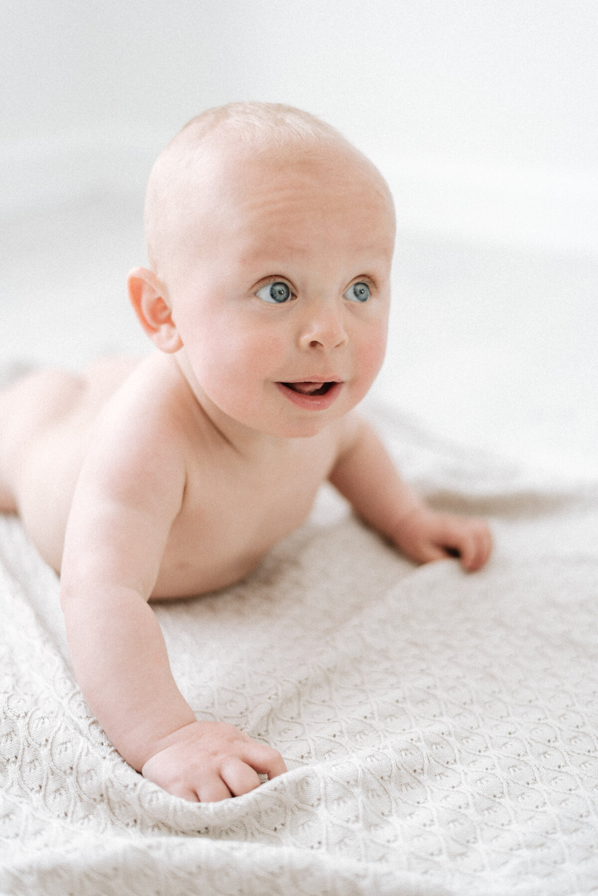 baby laying on his front at milestone photoshoot in billingshurst