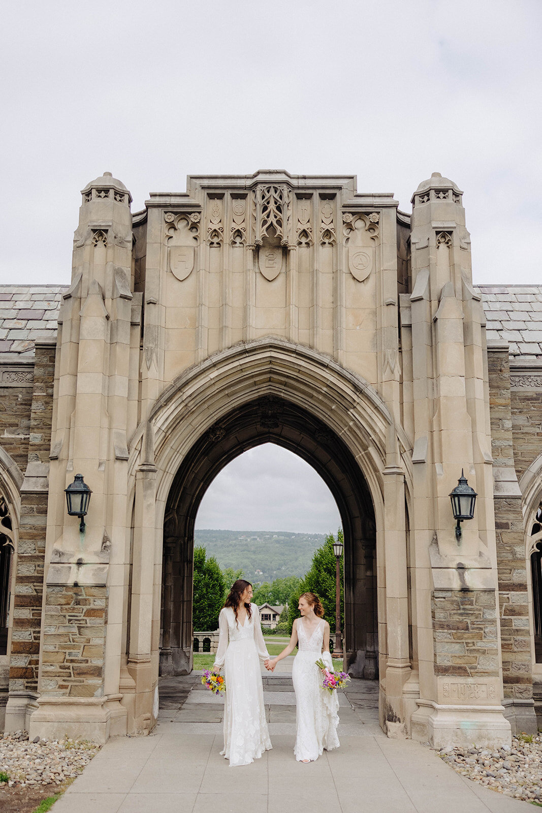 Two brides walking through Cornell Universityfor  wedding