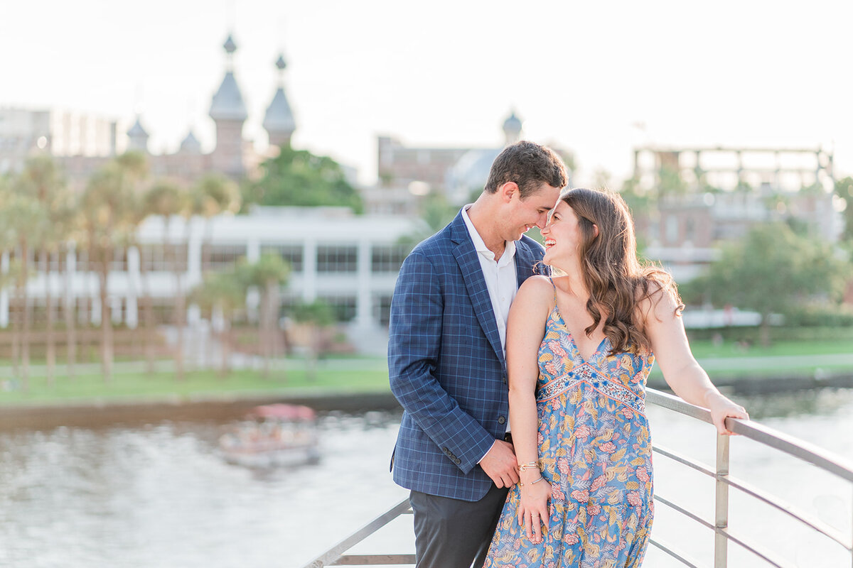 Smiling couple leaning against a railing overlooking Hillsborough River from Curtis Hixon vantage point
