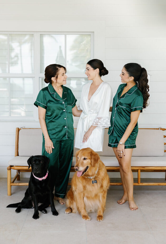  A relaxed and happy moment as the bride, her mother, sister, and two dogs enjoy time together before the wedding. Beautiful destination wedding photography by Claudia Amalia Photography in the Florida Keys.