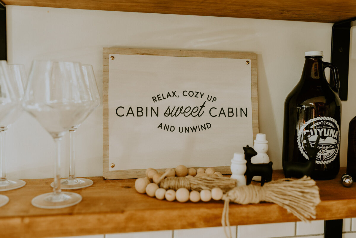 Cabin Sweet Cabin sign in kitchen of aframe.