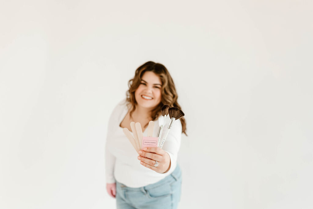 Macayla Hopper holding professional skincare tools used for facials and waxing services in Hartselle AL