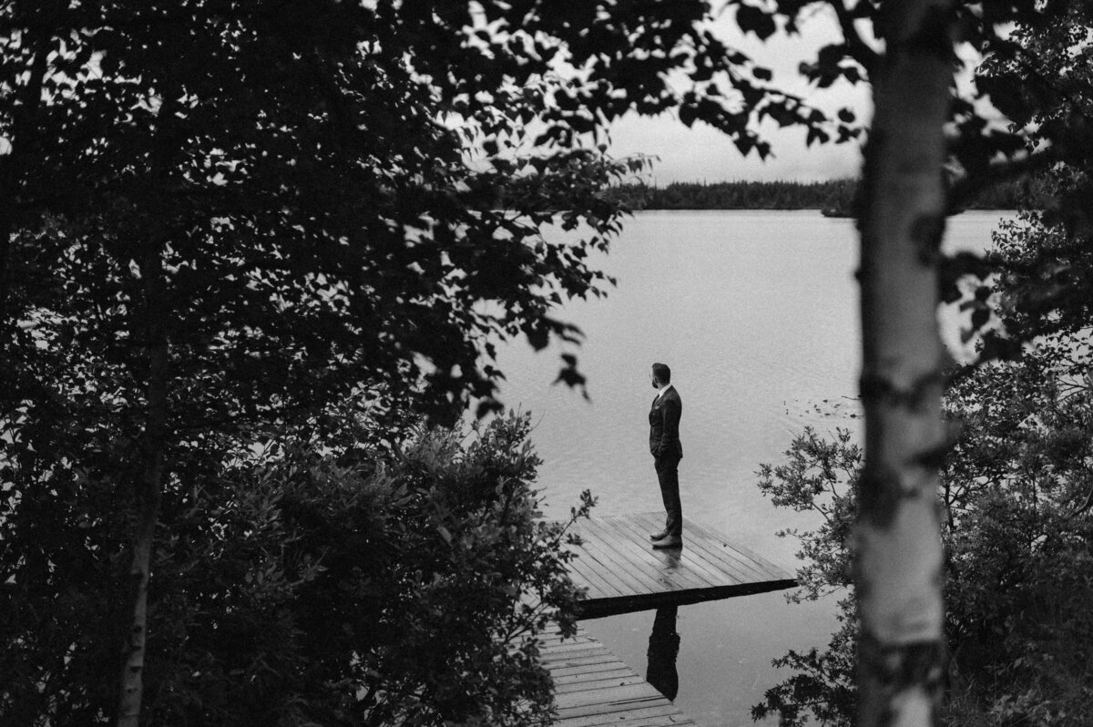 Groom waiting for a first look at Winterlake Lodge