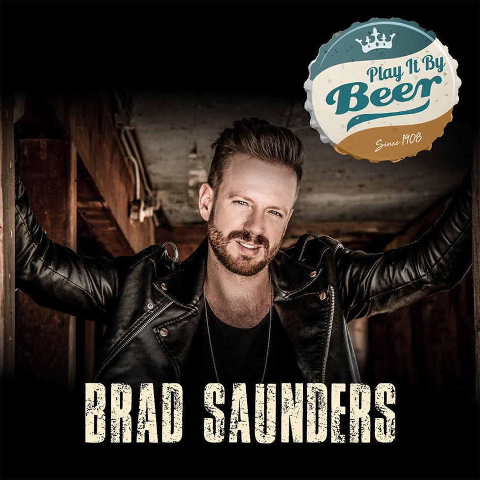 Single Cover Title Play It By Beer Artist Brad Saunders arms outstretched leaning against door frame of wood shack wearing black leather jacket