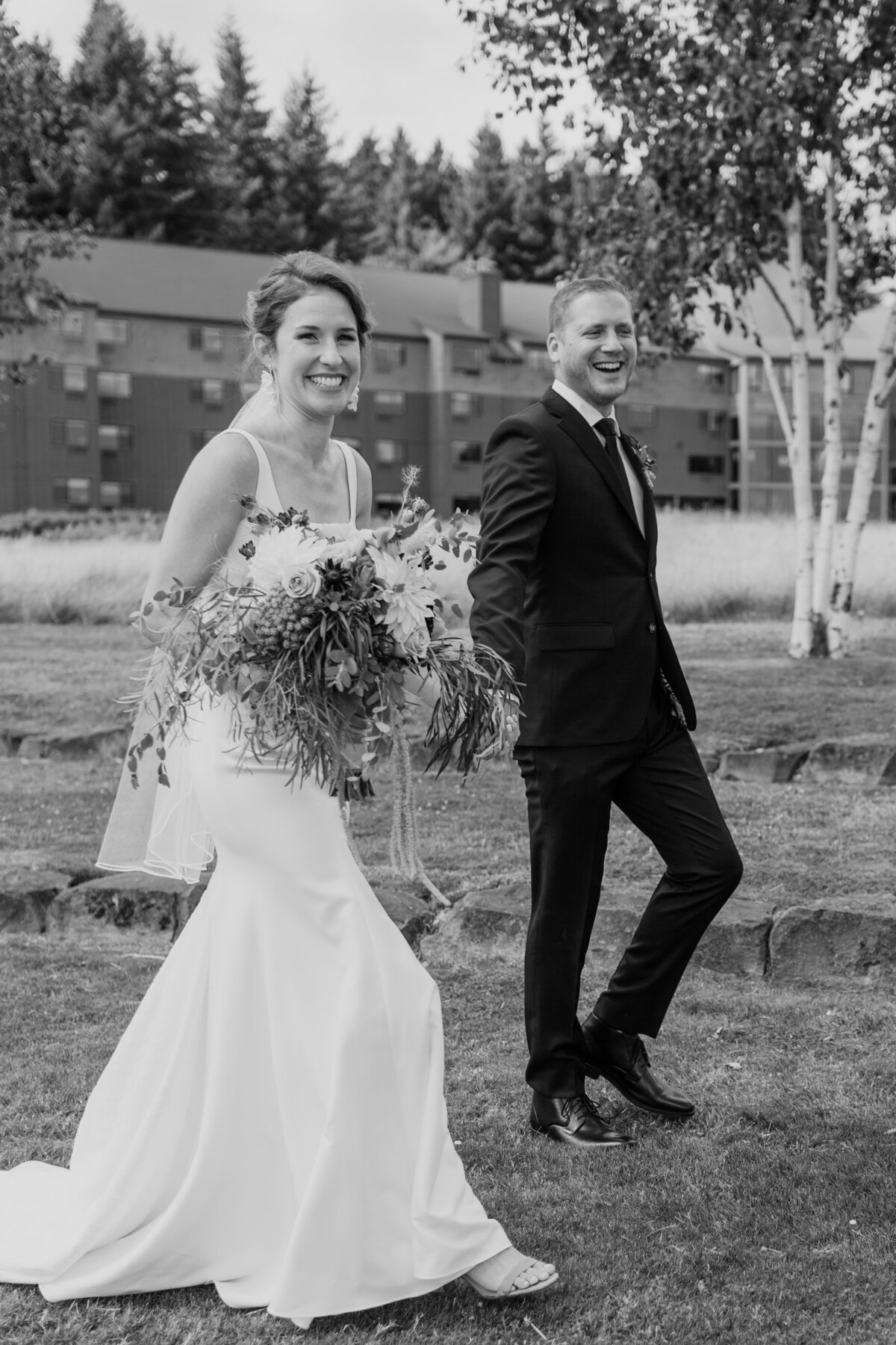 A happy candid of a couple walking at Skamania Lodge captured by Fort Worth wedding photographer, Megan Christine Studio