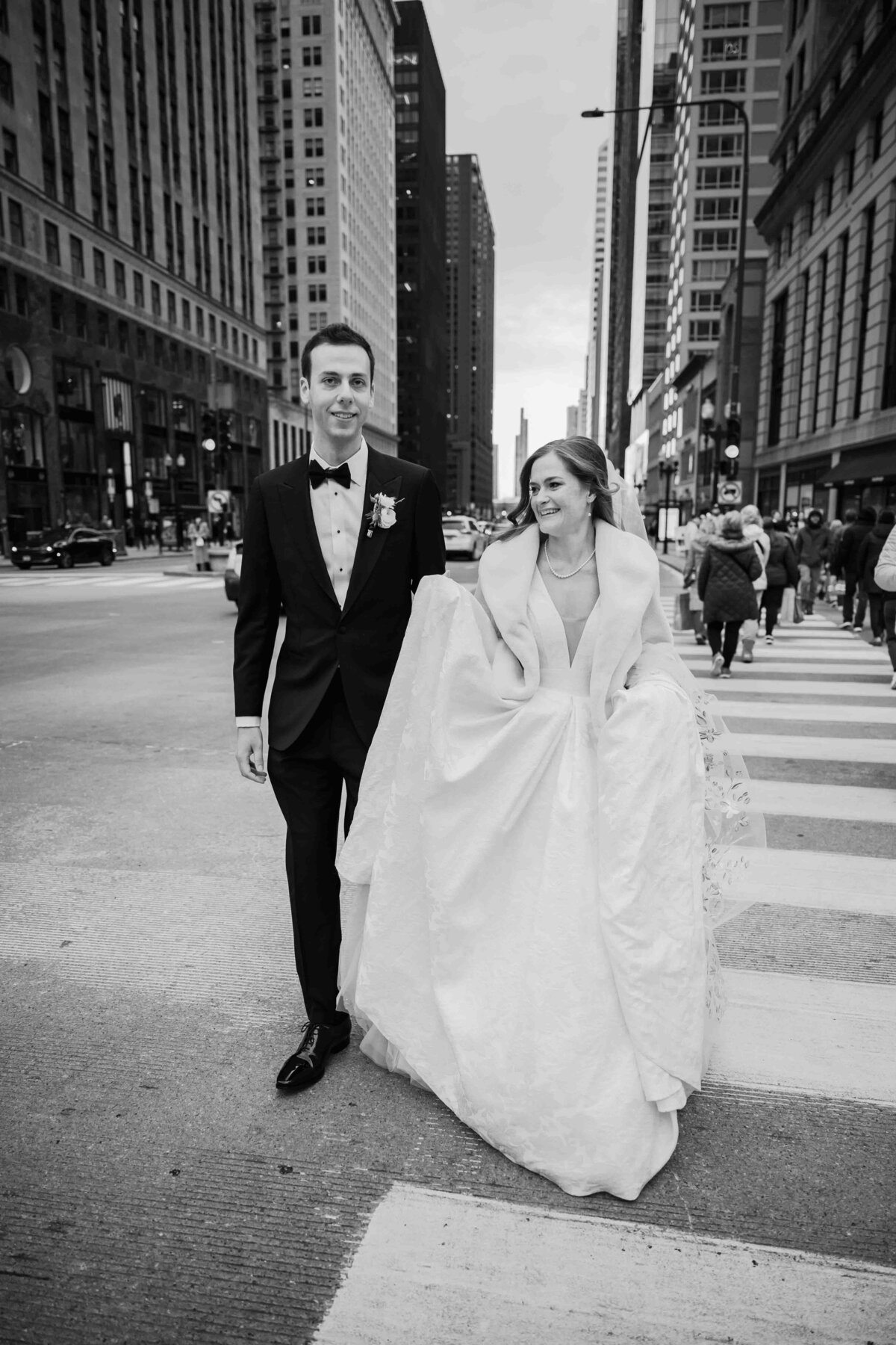 bride and groom walk on a CHicago city street