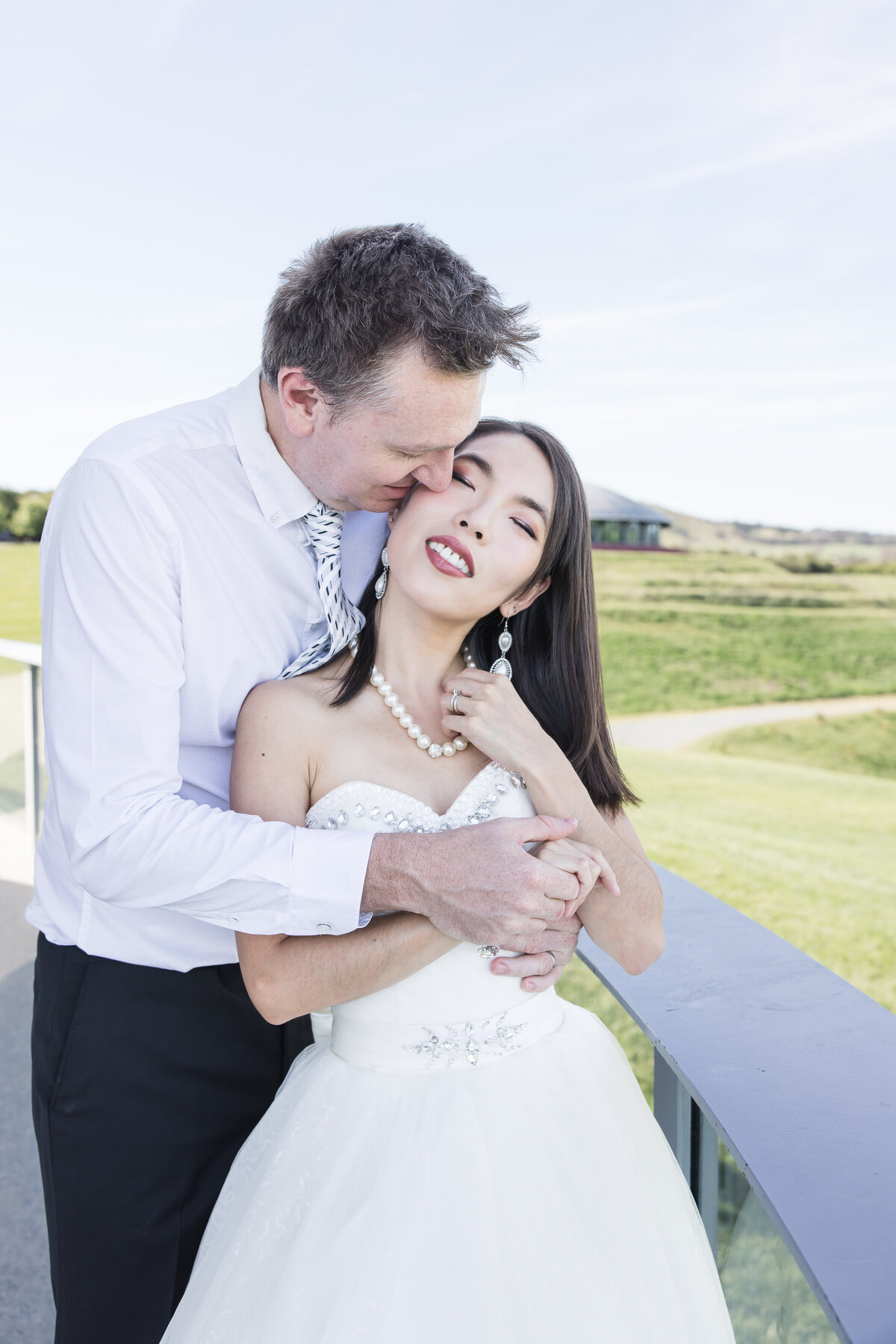 Bride and groom embracing outdoors