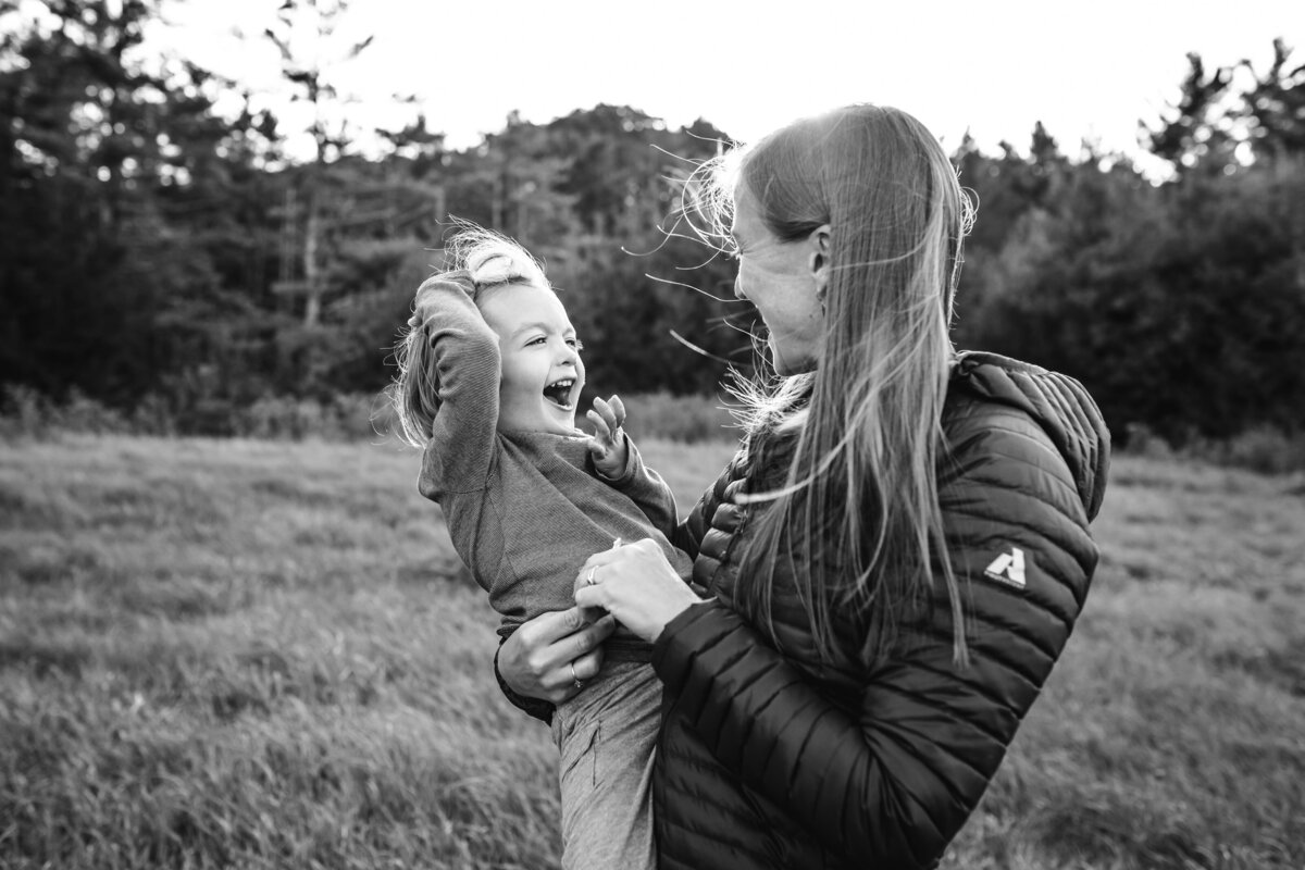 black and white of mom holding three year old son by Vermont Family Photographer