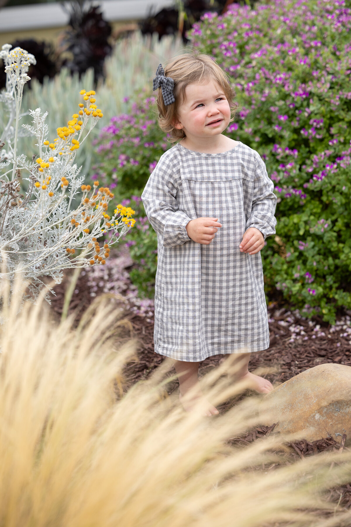 toddler waring a dress with a blue bow