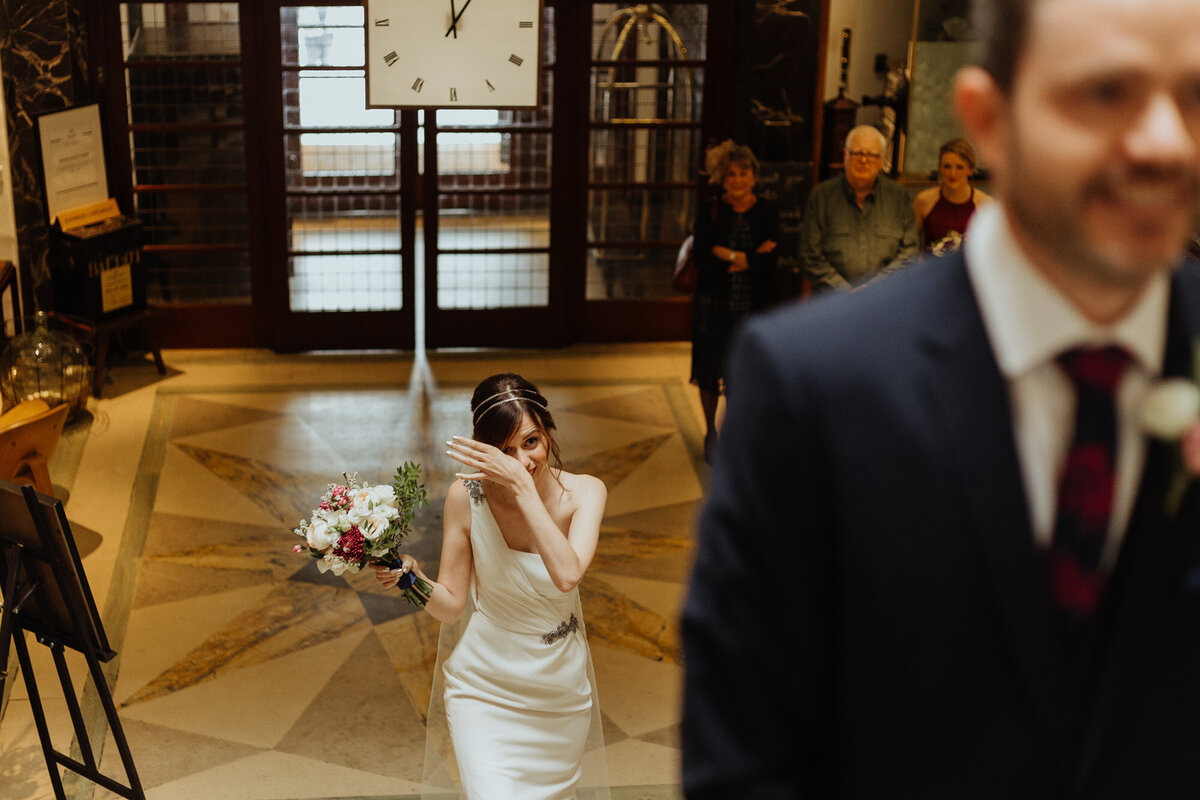 bride crying walking up to groom