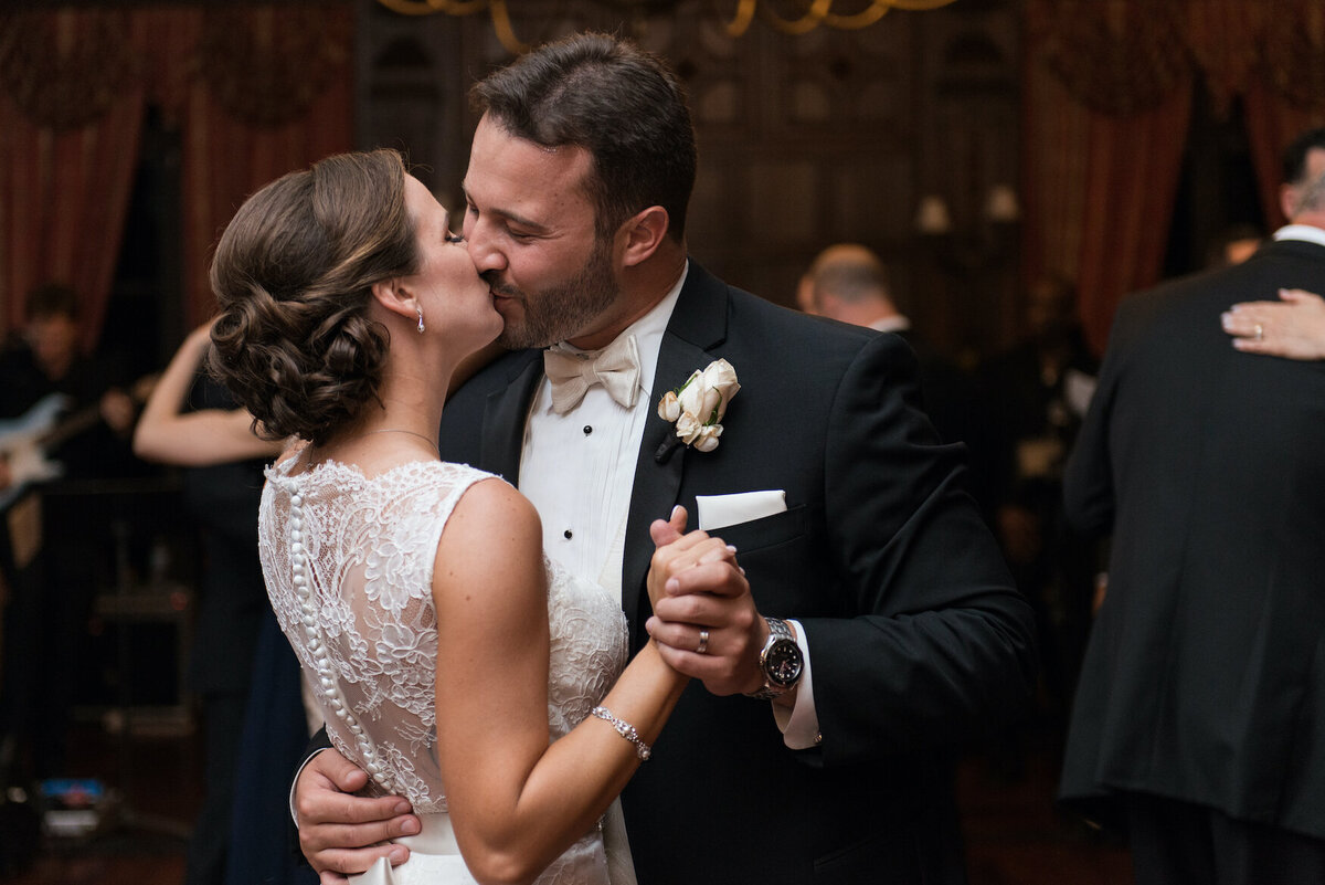 bride and groom kissing in the ballroom at de Seversky Mansion