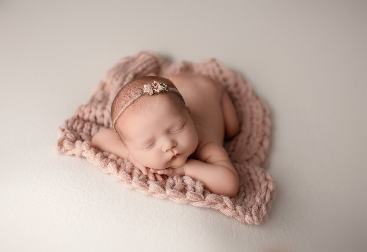 newborn photos done in denver studio of baby girl on soft pink blanket