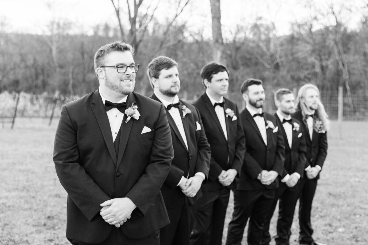 Groom and groomsmen lining up for wedding ceremony