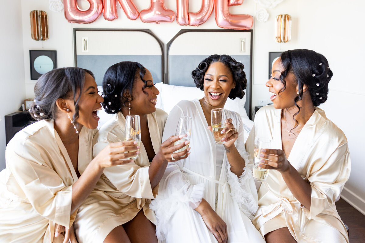 bride laughing with bridesmaids