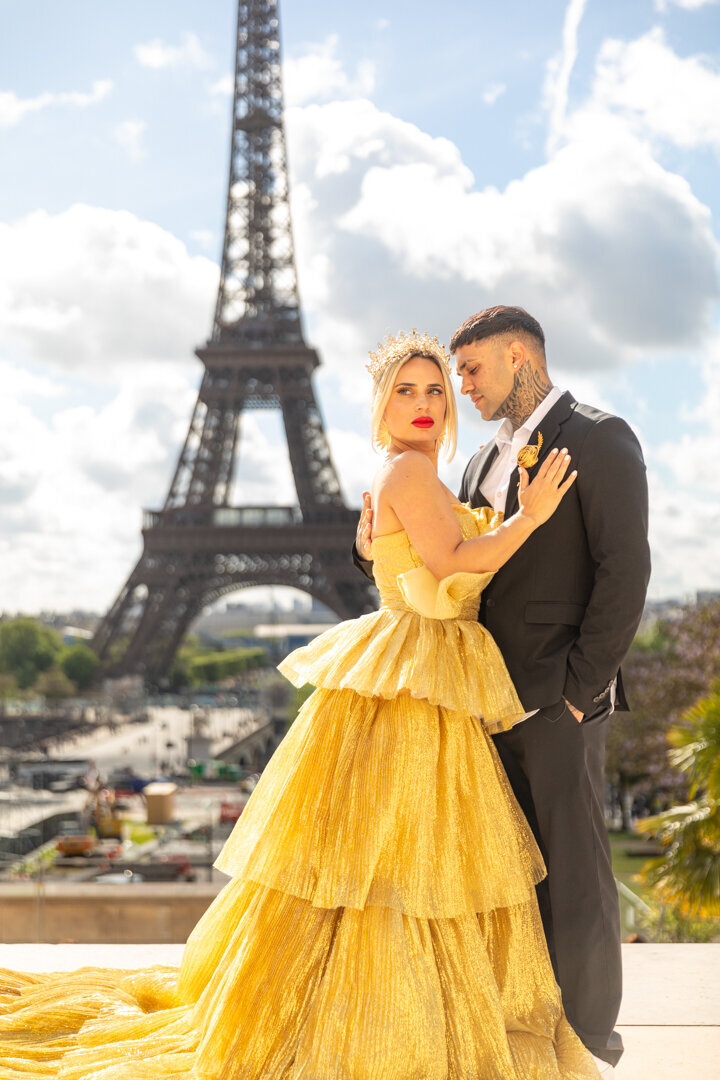Luxury Paris couple photography, bride in gold princess dress with crown, tattooed groom, Eiffel Tower view