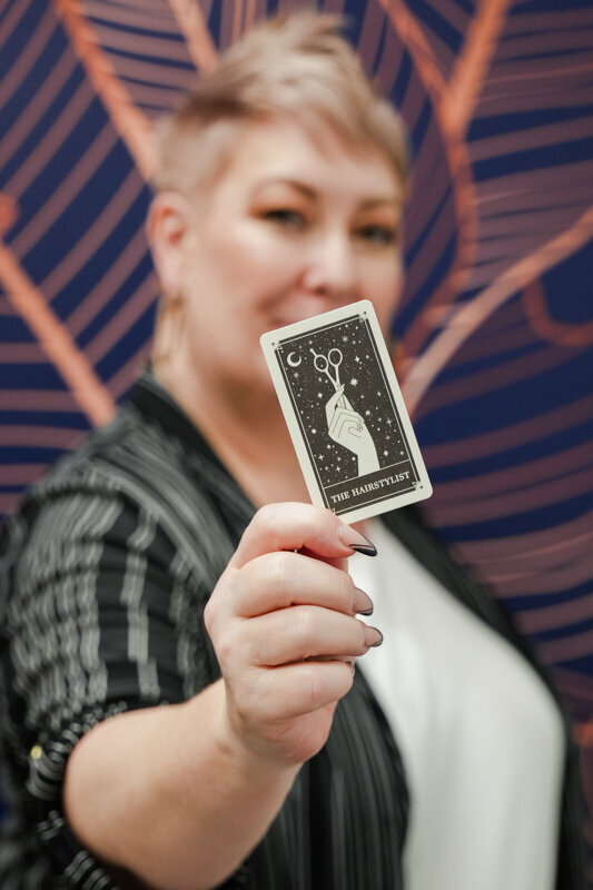 Kirsty Shelley holding up business card in front of camera