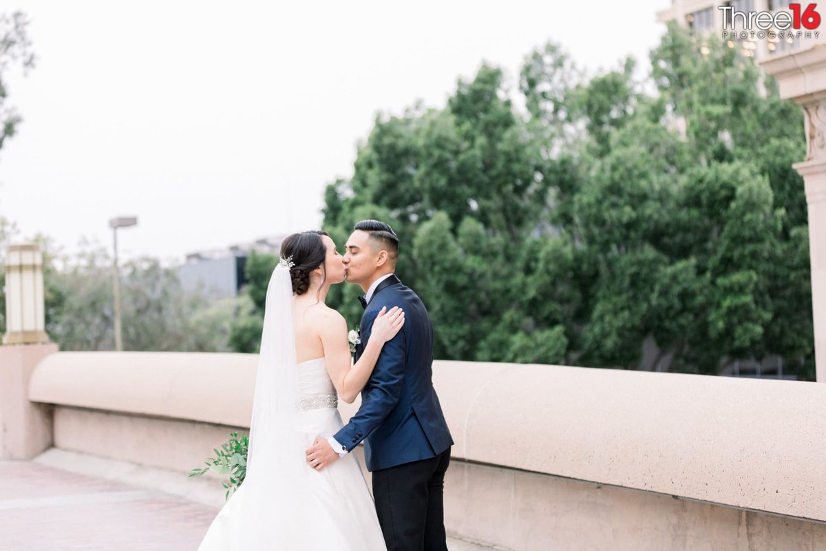Bride and Groom share a kiss on the rooftop at the NOOR in Pasadena, CA