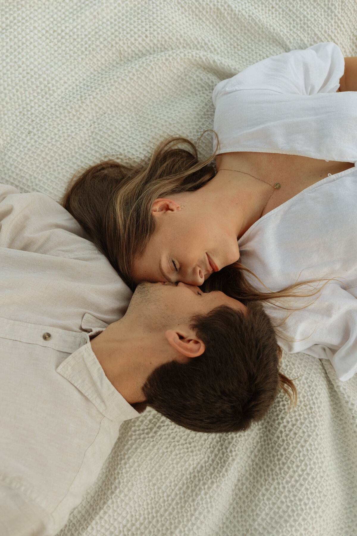 Couple enjoying a cozy picnic with wine and charcuterie at a tropical vineyard

