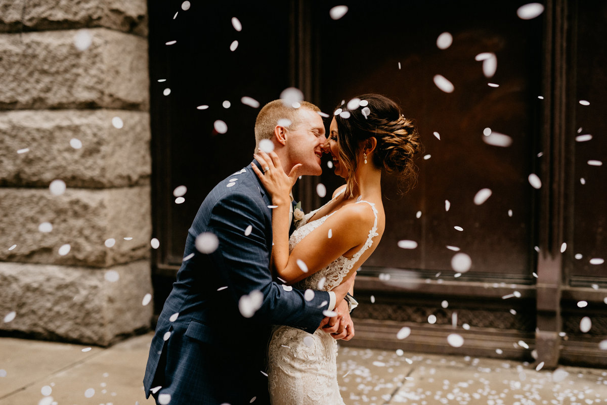 wedding couple kissing in confetti