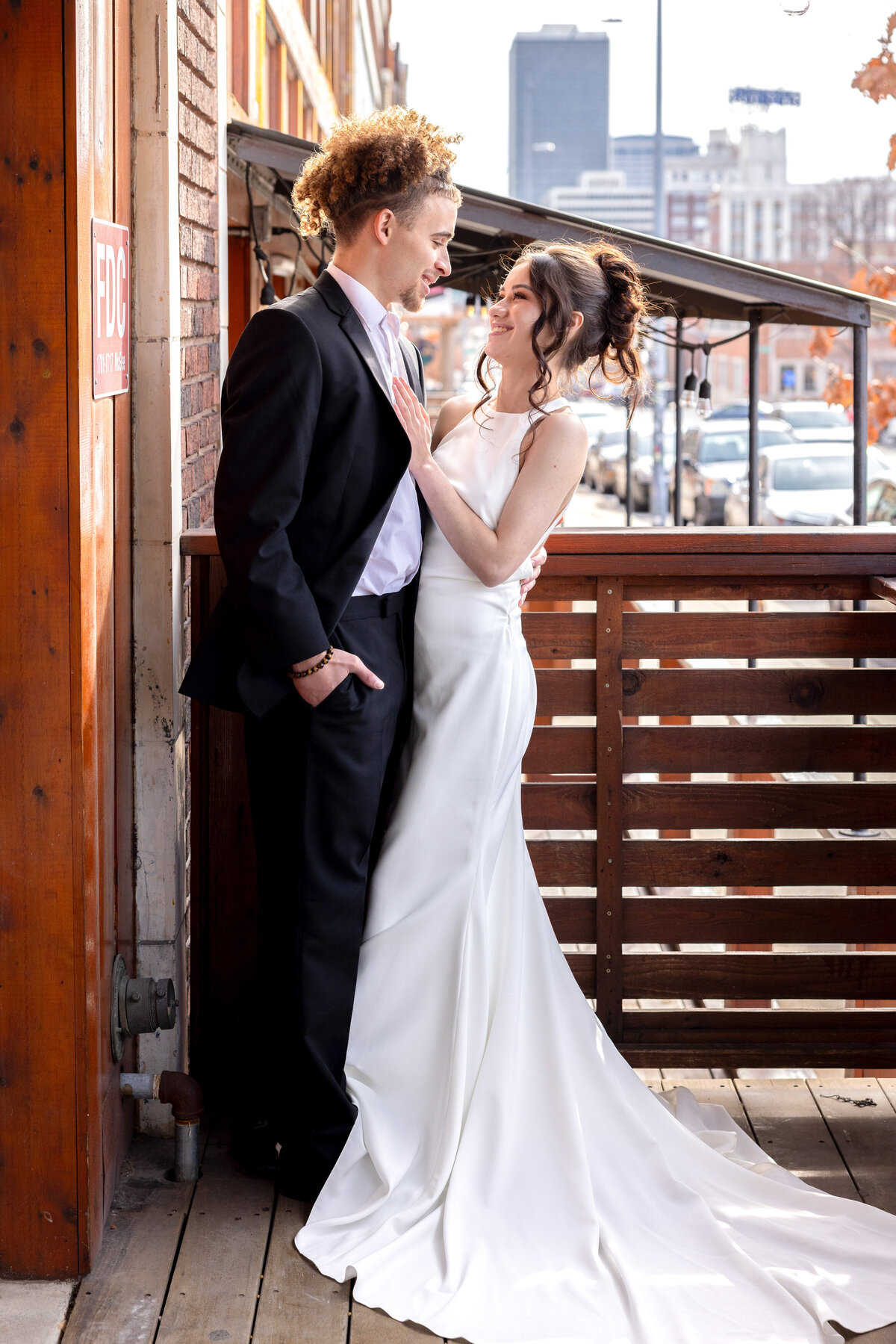 couple embracing with brides hand on grooms chest and looking into his eyes