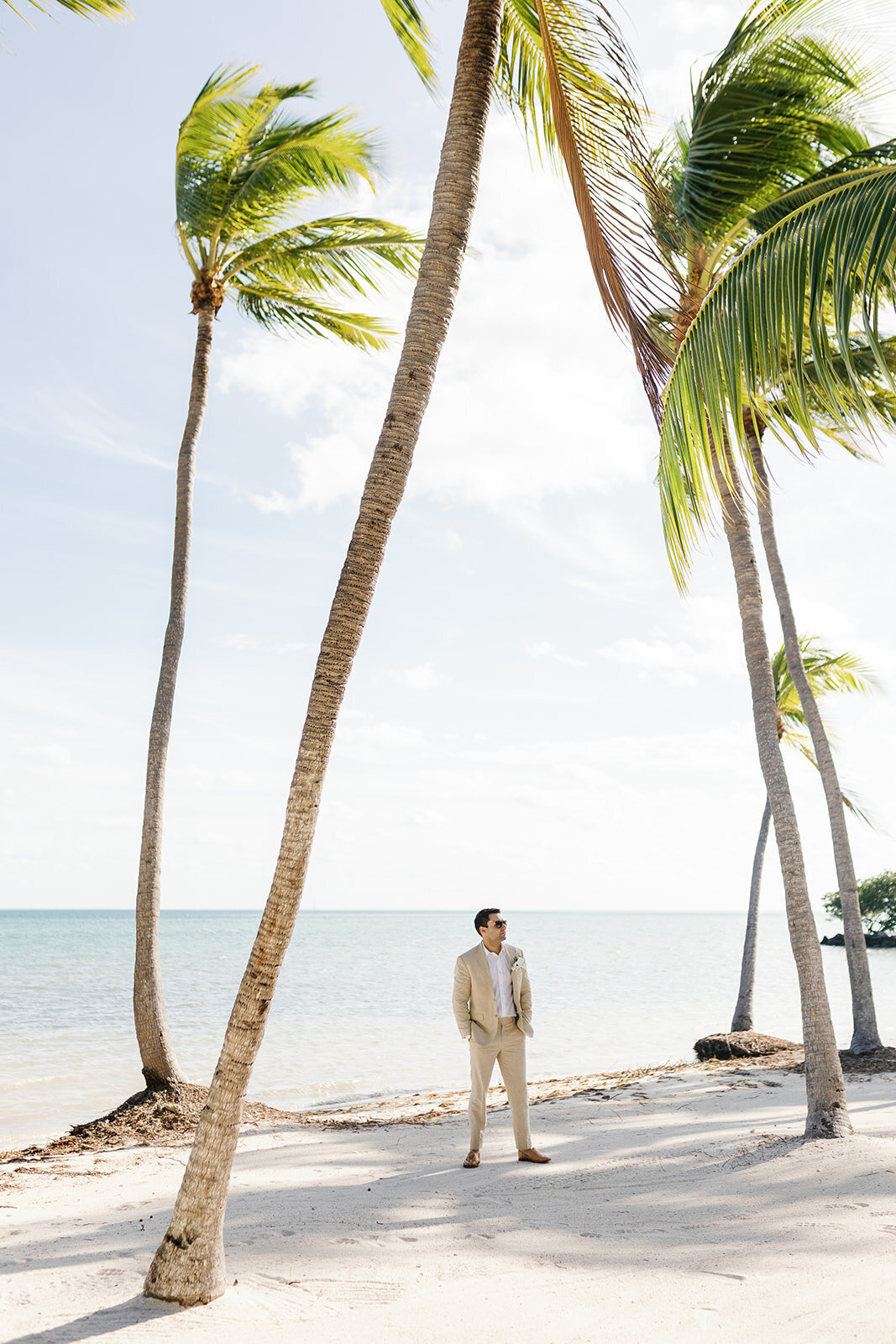 A breathtaking view of the calm Florida Keys waters and swaying palms, setting the scene for a dreamy beach wedding.