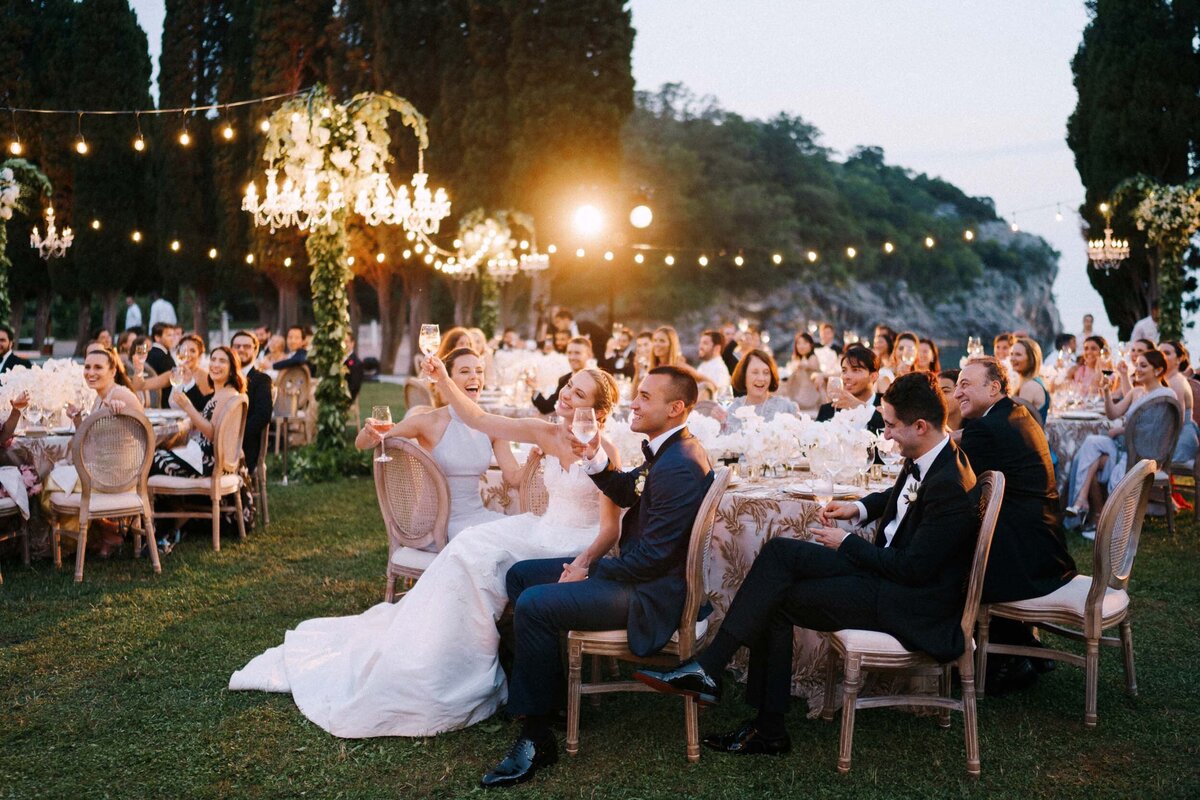 Candid moment of laughter and celebration at an evening wedding reception, captured by a Toronto event and wedding photographer