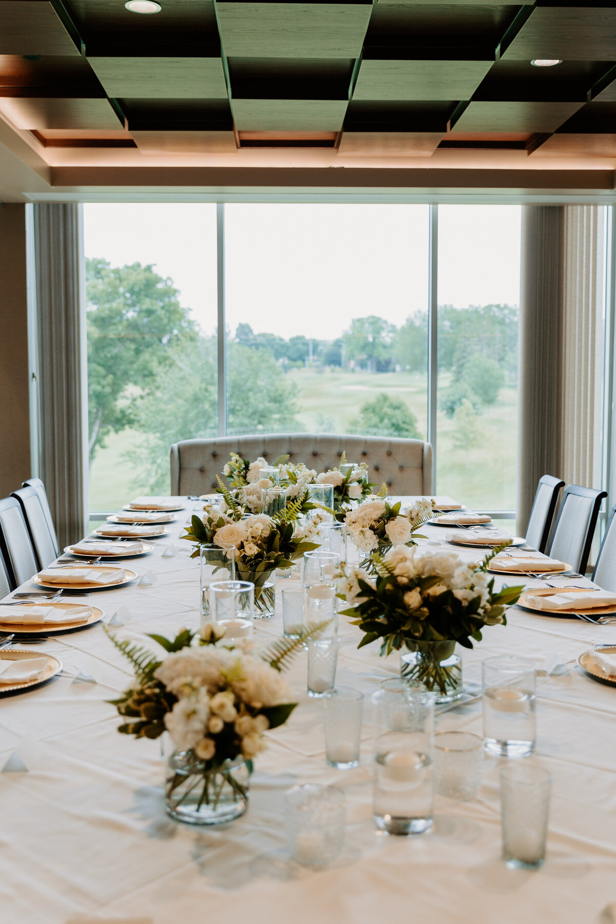 A wedding reception table with flower bouquets throughout