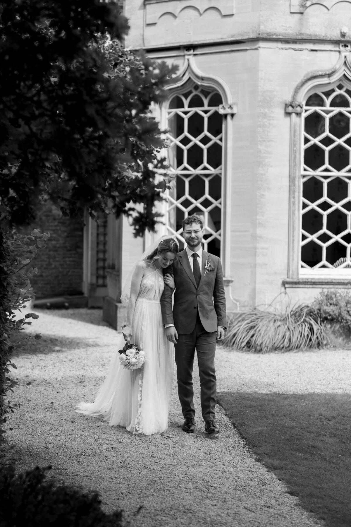 The bride and groom walk together at Frampton Court Estate, Gloucestershire