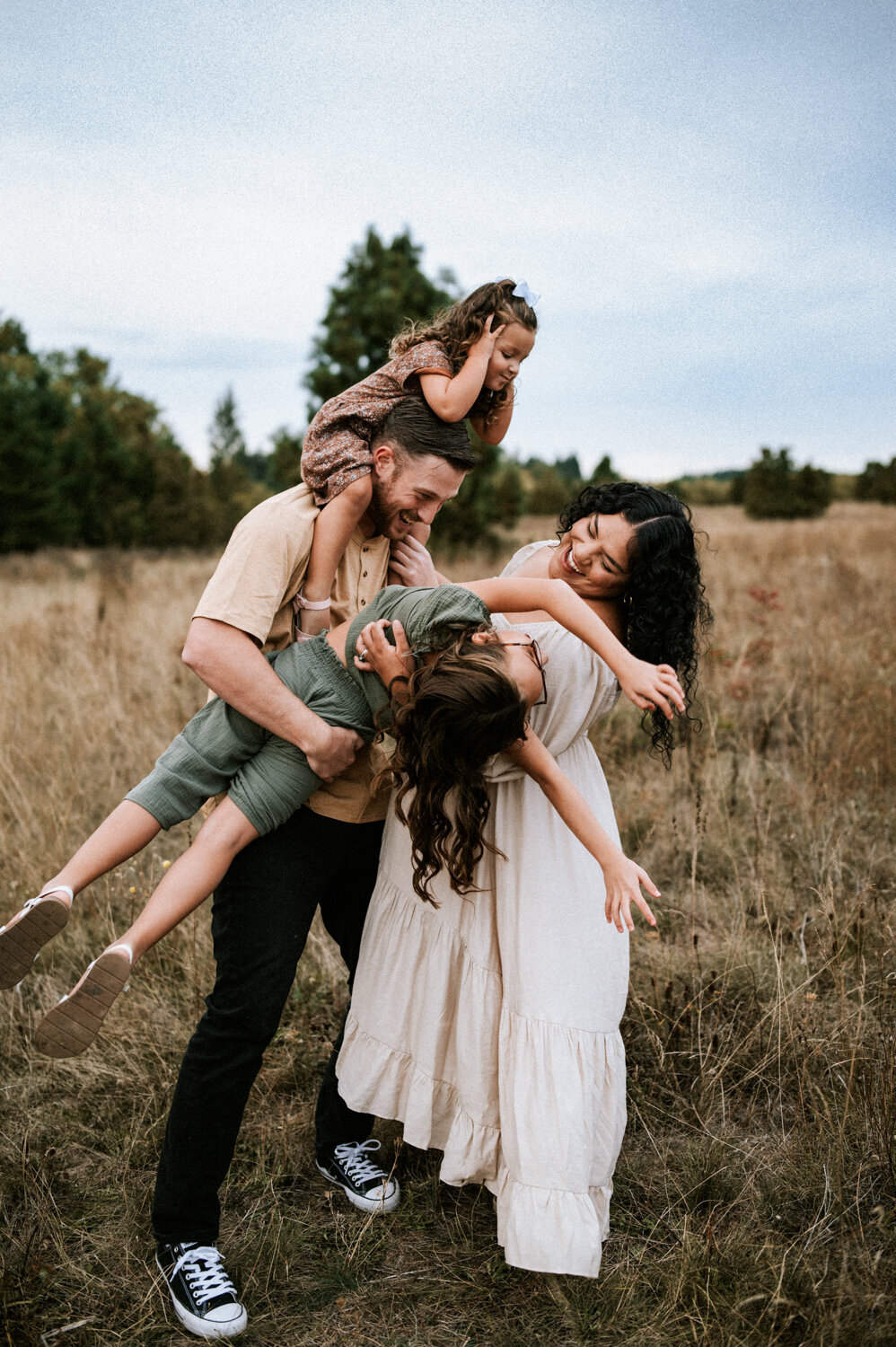 family laughing and having fun at the park