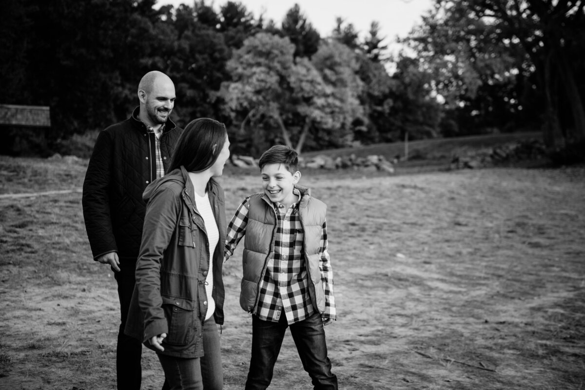 black and white portrait of son holding mom's hand