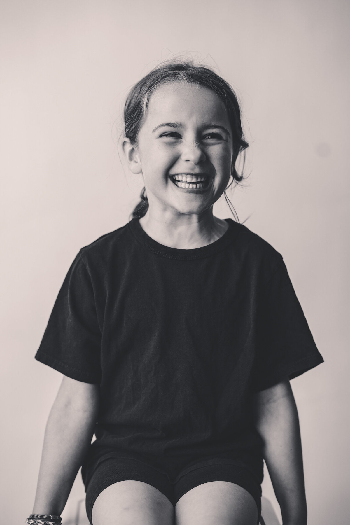 Young girl laughs off camera during Personality Portrait Session in Charleston, SC.