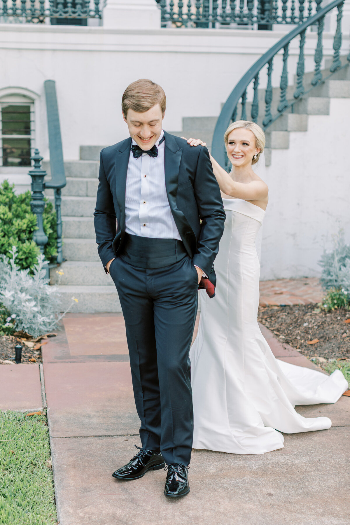 A bride and groom have a first look in front of Nottoway Plantation.
