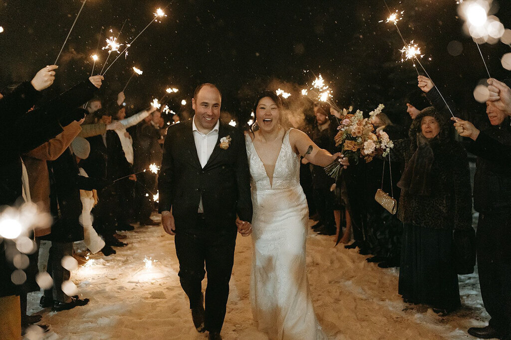 Bride and groom during reception sparkler exit, by Court Amber Photography, joyful and adventurous wedding photographer in Calgary, Alberta. Featured on the Bronte Bride Vendor Guide.