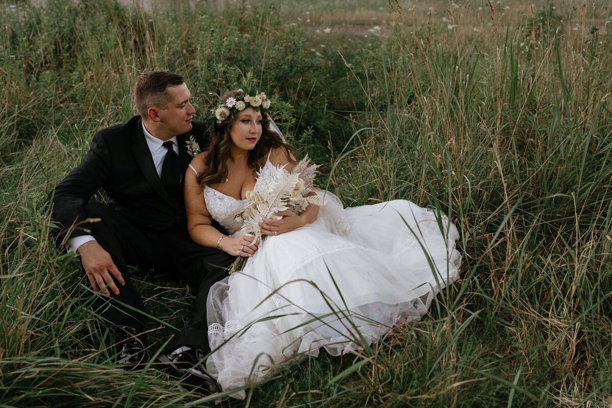 Couple relaxes in tall grasses at Cleveland Wedding