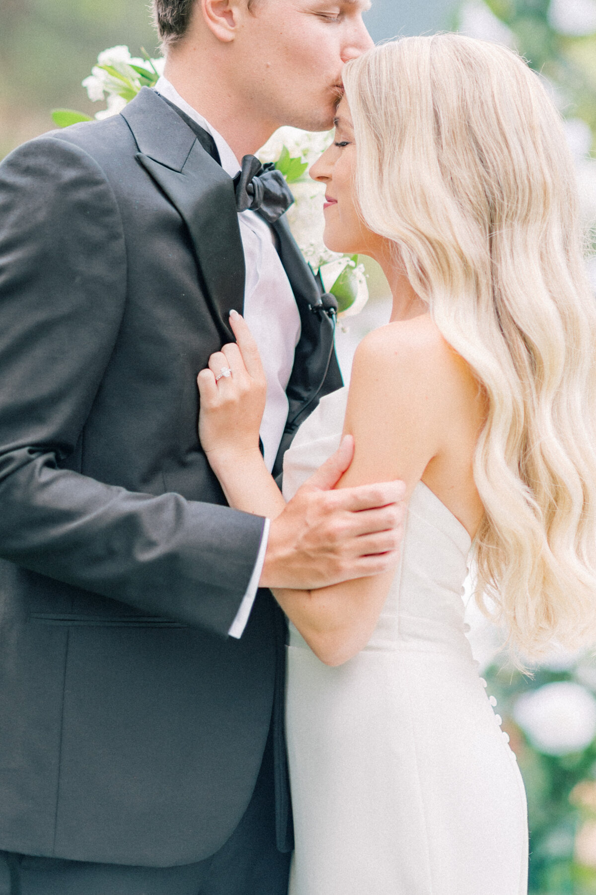 bride and groom close embrace on wedding day