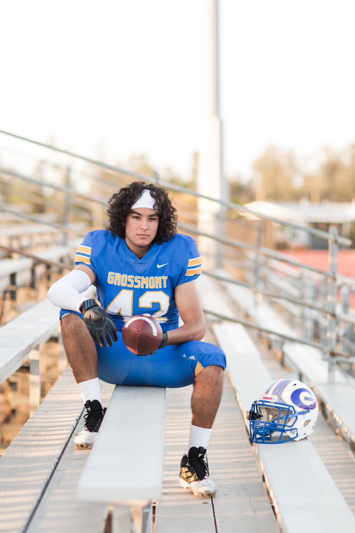 football-player-senior-portraits-san-diego-sitting-in-stands