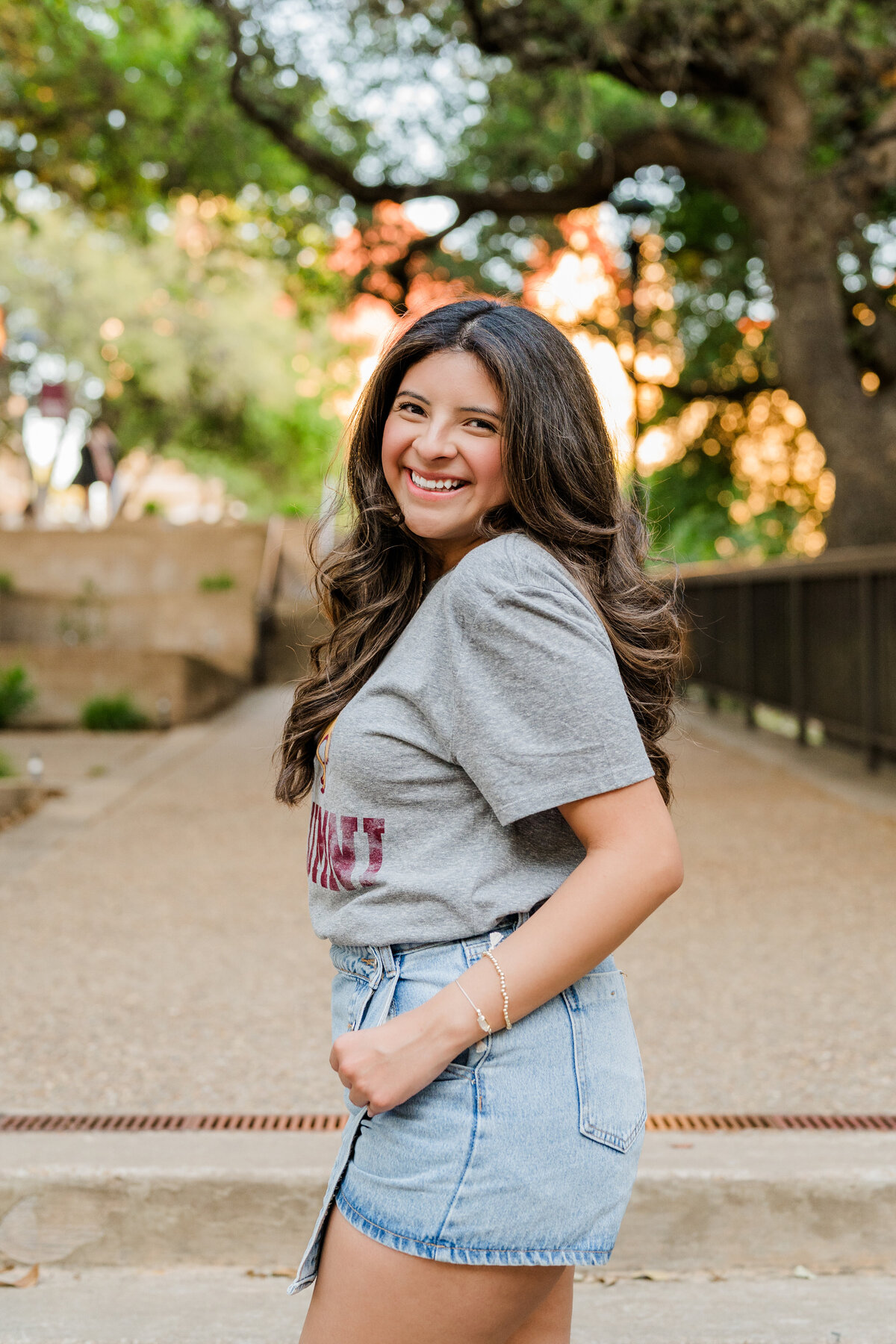 Texas state grad on steps leading to Old Main 
