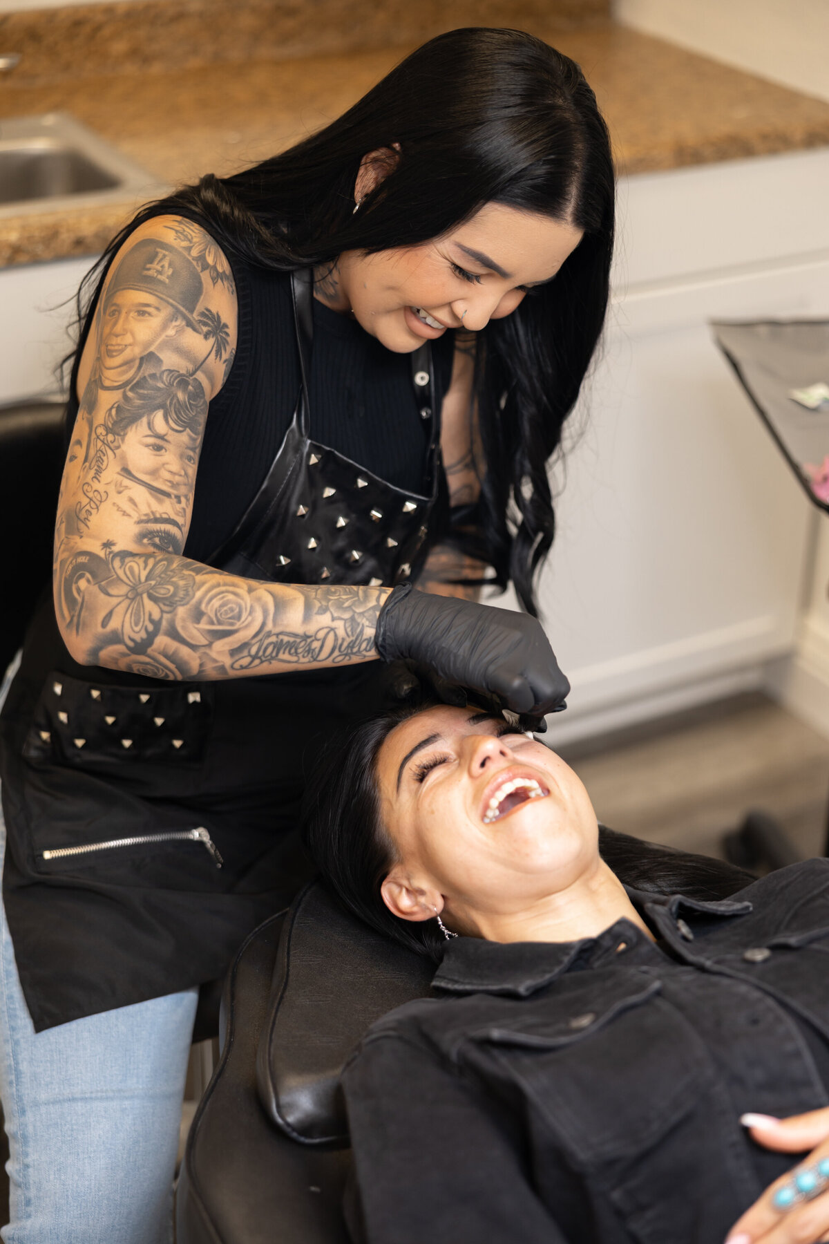 Professional makeup artist applying brow pigment to client during a beauty session. Photograph by Yucaipa branding photographer Kaitlyn Dawn Photography.