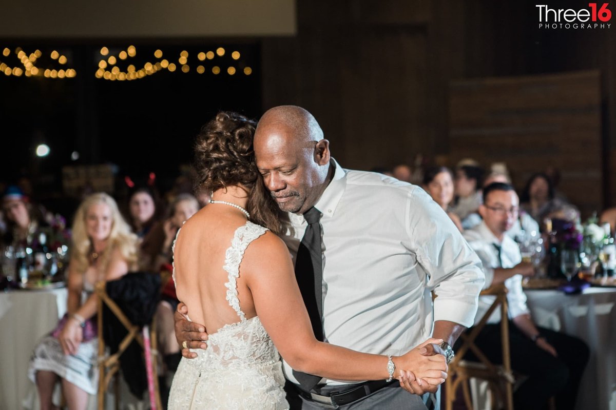 Bride dances with her father during her wedding reception