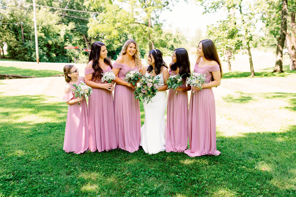 Portrait of Bride with her bridesmaids laughing and enjoying the wedding day.