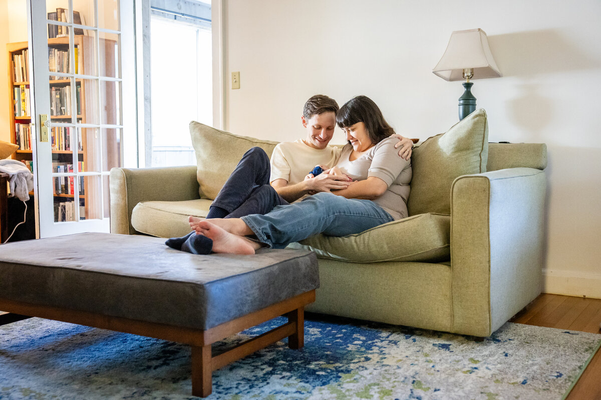 Mom and Dad on couch holding baby