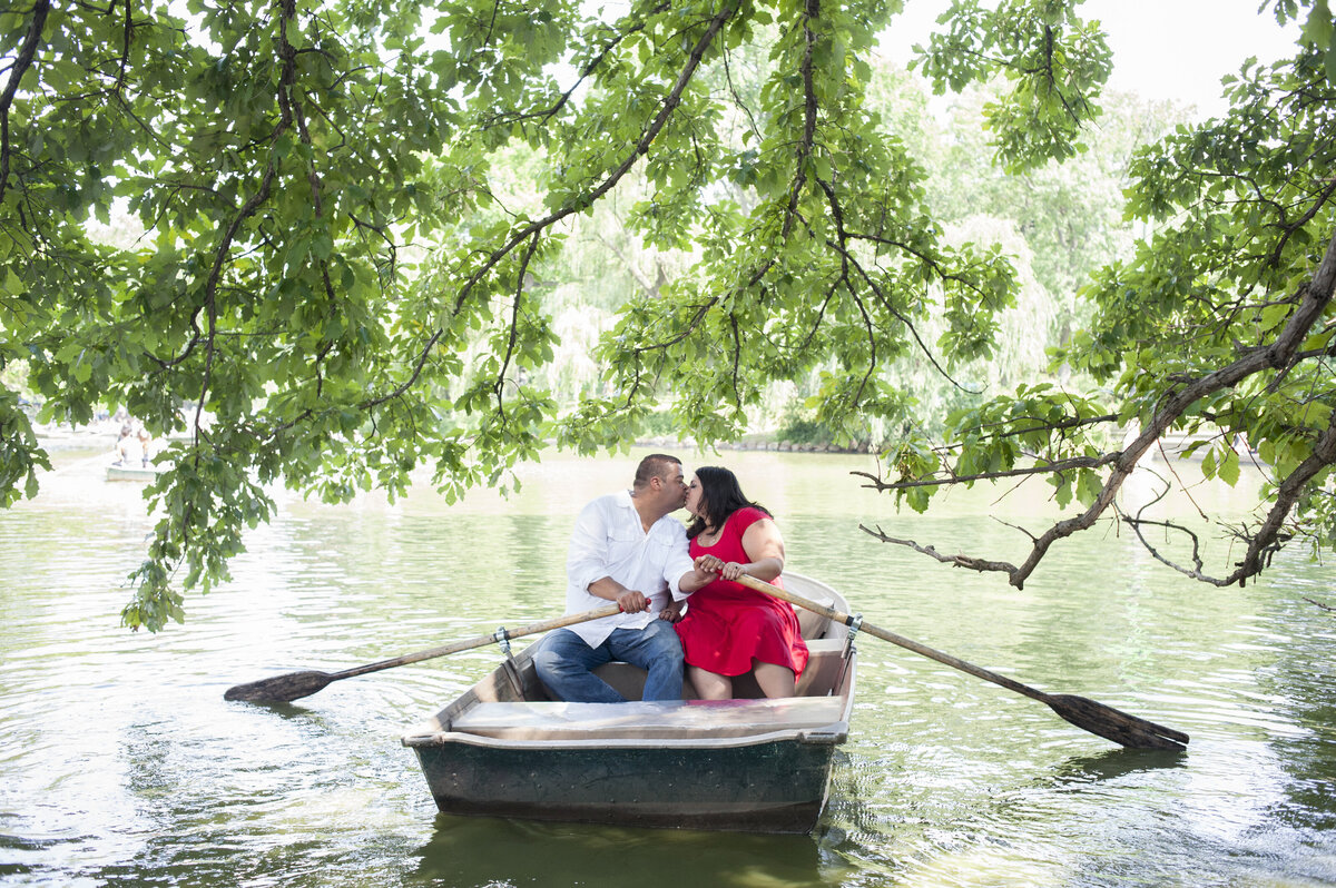 A couple kissing in a rowboat 